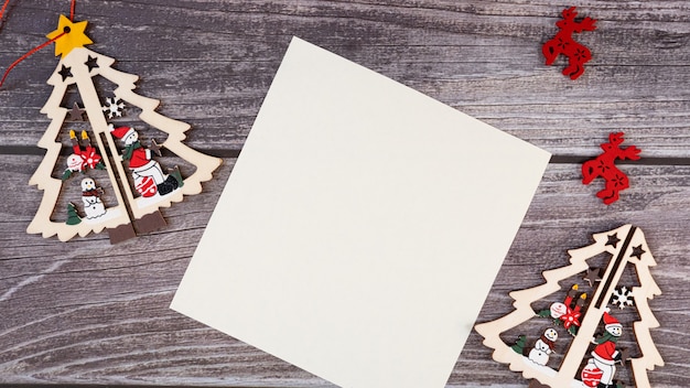 Merry Christmas blank greeting card on a wooden background.