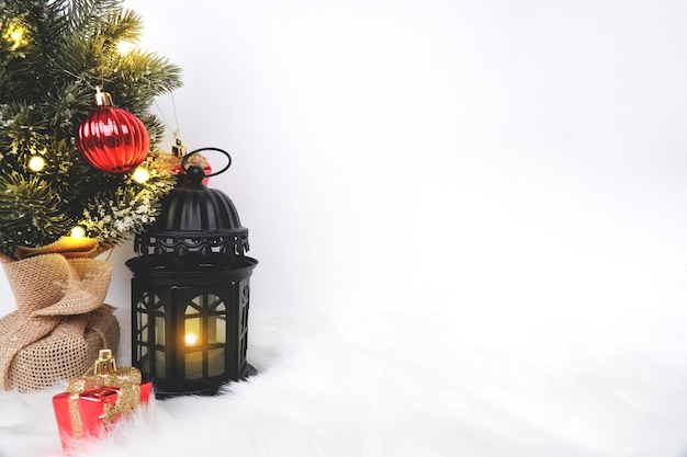 Merry Christmas decorated with ornament candle warmer lantern and light white copy space