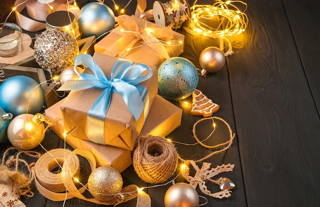 Merry Christmas. Gift boxes, Christmas balls and decorations on a dark background. Side view, copy space.