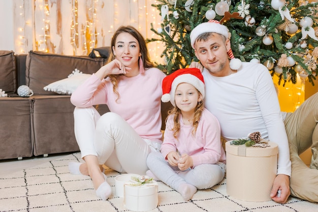 Merry Christmas happy family mother father and children with holiday gifts