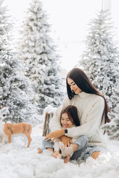 Merry Christmas and Happy Holidays Cheerful mom and her cute daughter girl