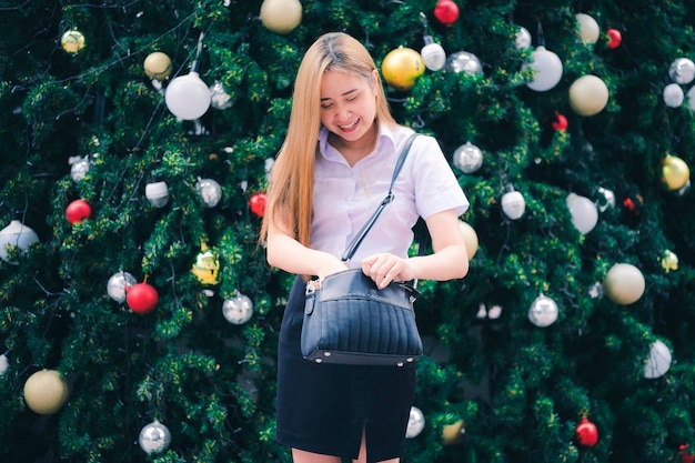 Merry Christmas And happy holidays a cute beautiful woman decorated the Christmas tree