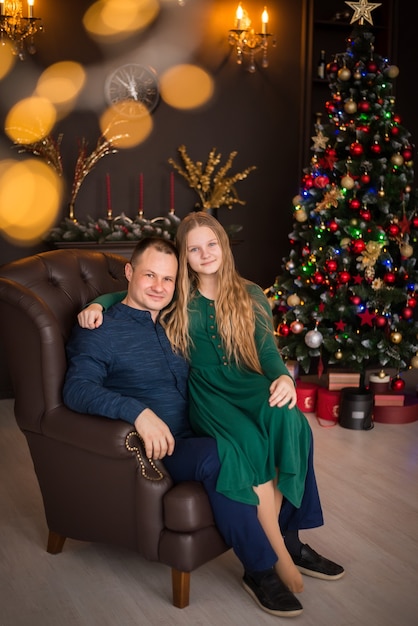 Merry Christmas and Happy Holidays. family, father and daughter on the background of a Christmas tree.