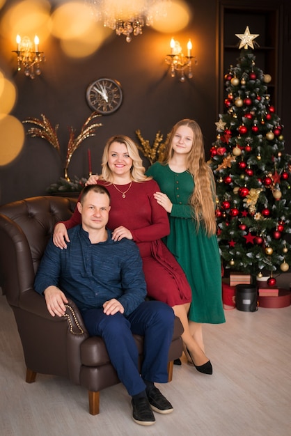 Merry Christmas and Happy Holidays. happy family in a beautiful room near the christmas tree