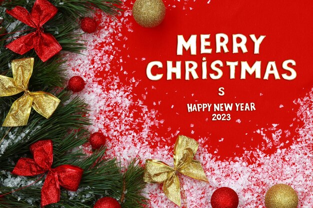 Merry Christmas and Happy New Year 2023 christmas composition on red background Fir branches