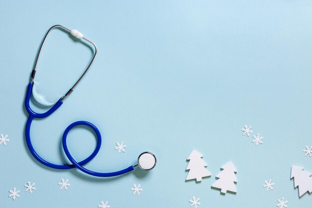 Merry Christmas and Happy New Year medicine concept stethoscope snowflakes small wooden toys