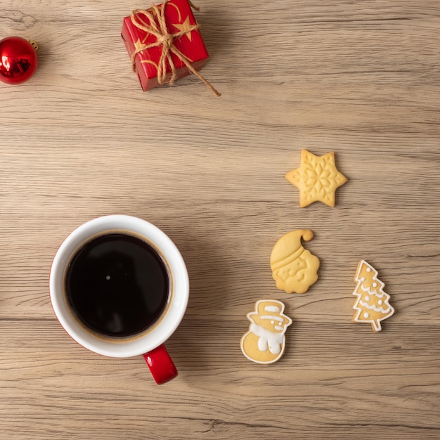 Merry Christmas with homemade cookies and coffee cup on wood table background Xmas eve party holiday and happy New Year concept