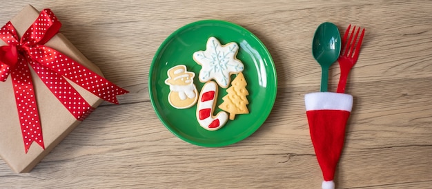 Merry Christmas with homemade cookies, fork and spoon on wood table background. Xmas, party and happy New Year concept