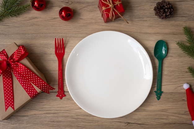 Merry Christmas with plate fork and spoon on wood table background Xmas party and happy New Year concept