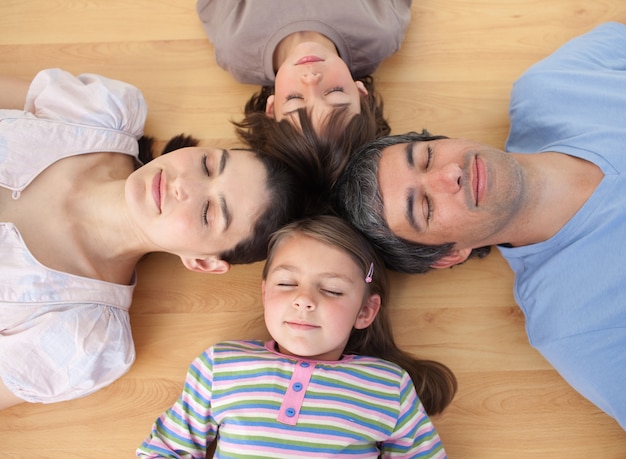 Merry family sleeping lying on the floor