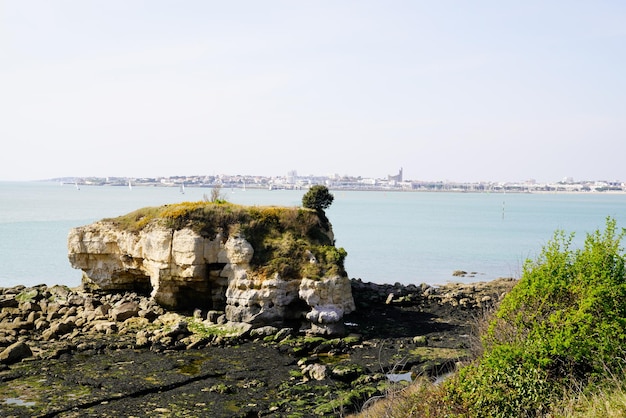 Meschers eroded coast with a view of the city of royan in the background in MescherssurGironde french Atlantic coast