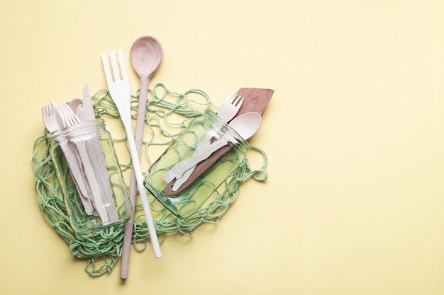 Photo mesh shopping bag with glass jars and wooden kitchen utensils