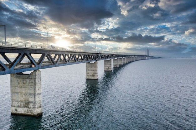 Mesmerizing aerial view of the bridge between Denmark and Sweden under the cloudy sky