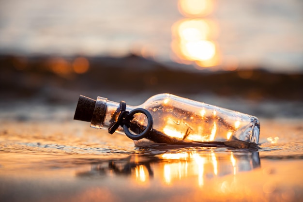 Message in the bottle against the Sun setting down