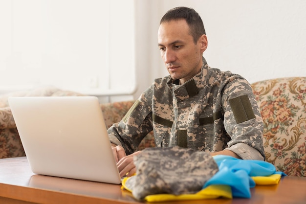 Message for world peace. military with laptop and flag of ukraine