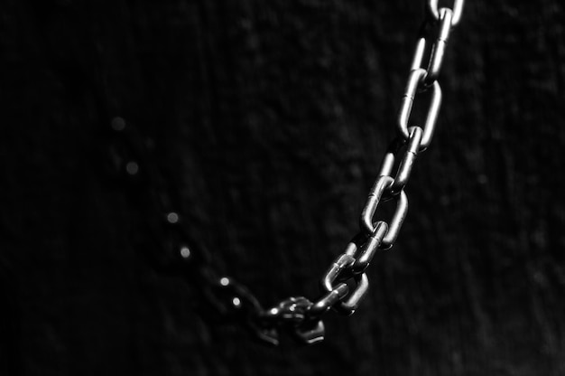 A metal chain on a concrete floor Silver chain for construction