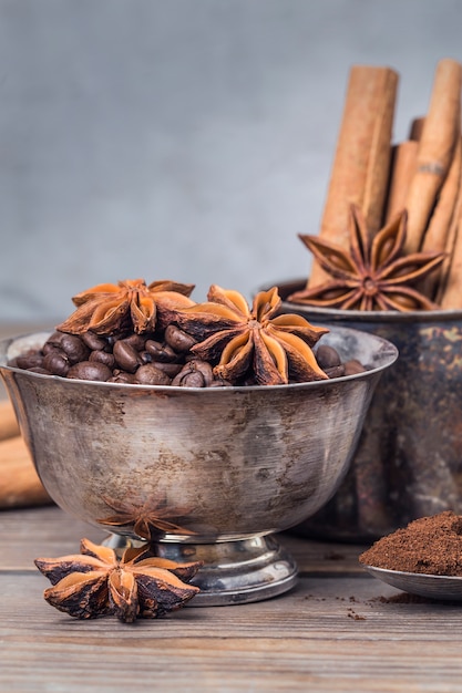 Metal containers with coffee beans and star anise