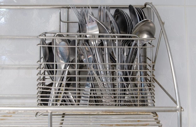 The metal cutlery stands for keeping the silverware near the white wall