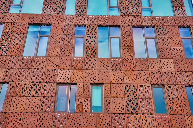 Metal cutout shapes cover exterior building broken up by windows