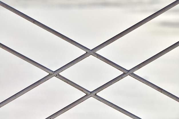 Metal fence with rhombus ornament on grey