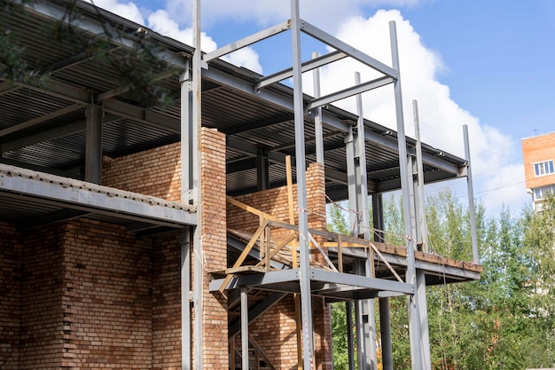 The metal frame of the new building with insulation and sandwich panels