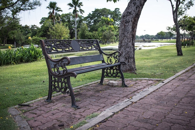 Metal garden chair on rock ground with green grass