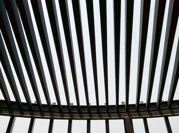 The metal grille roof on the rooftop of the modern building with the sunlight in the summer, front for the background.