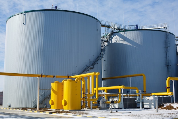 metal industrial tanks outdoor. technological building with pipelines at the industrial plant on wall. Equipment and appliances at the gas company. gas pipeline system with valve .