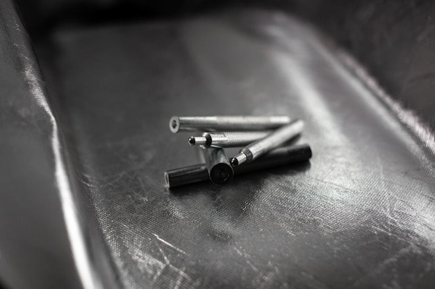 Metal iron tool, detail, lies on a silver background