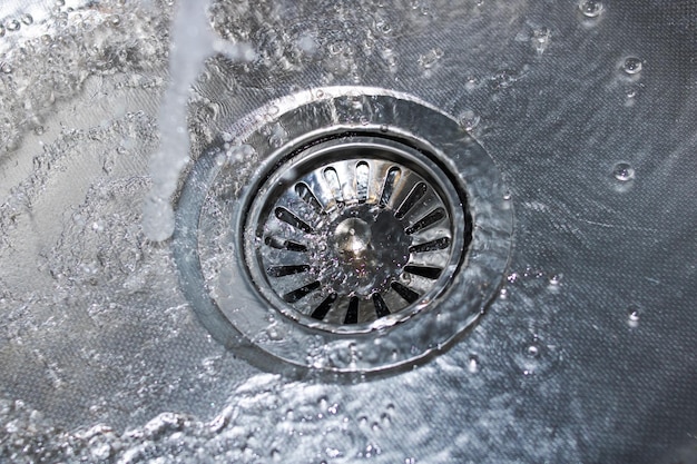 Metal kitchen sink and faucet close up