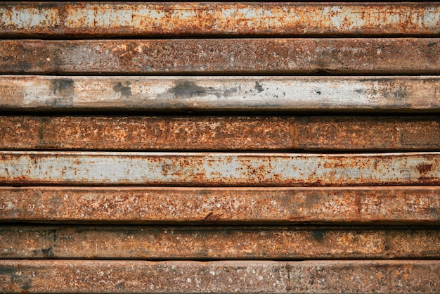 Metal old rusty background A stack of iron profiles Grunge style