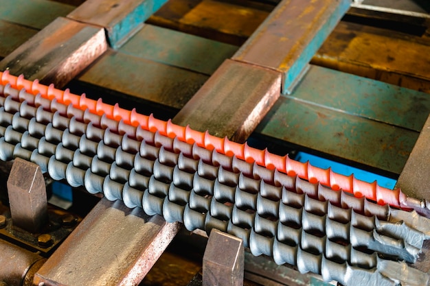 A metal rod heated in an induction furnace after processing Hot metal cools down Metalworking in the industrial workshop at the factory