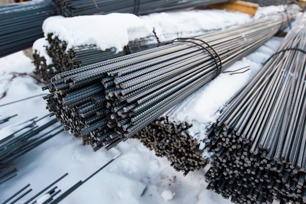 metal rods are packed on the snowy ground