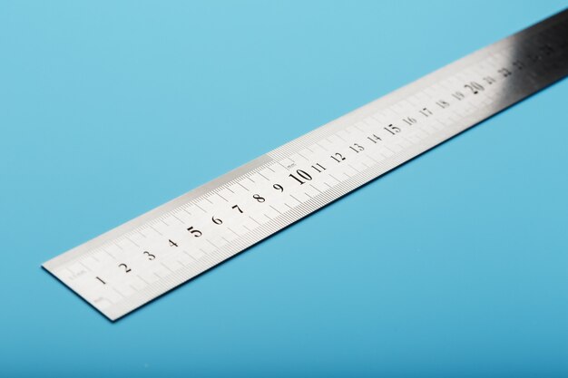 A metal ruler with a scale on blue is a superscape