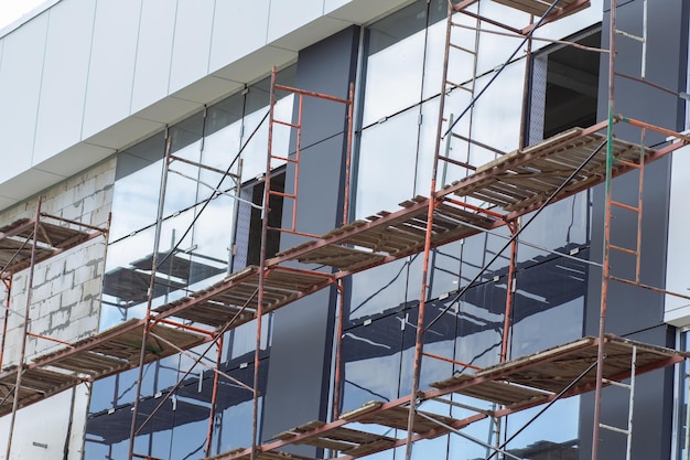 Metal scaffolding installed along the facade of building architecture for glazing facade and renew a