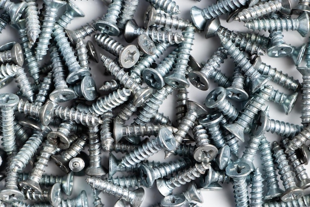 Metal screws on a white background. Set of building tools for repair.