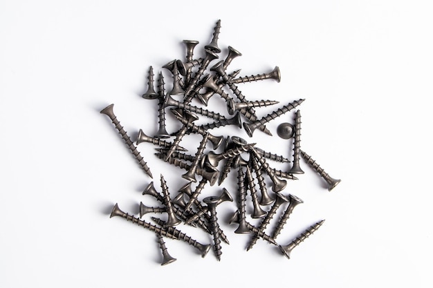 Metal screws on a white background Set of building tools for repair