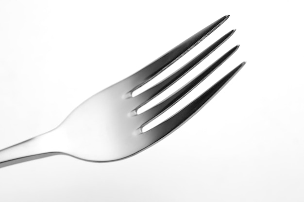 The metal shiny fork on white