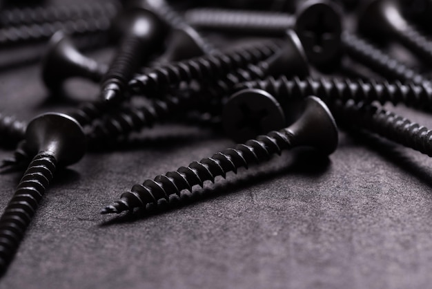 Metal Stainless Steel Self Tapping Screws on black wooden background