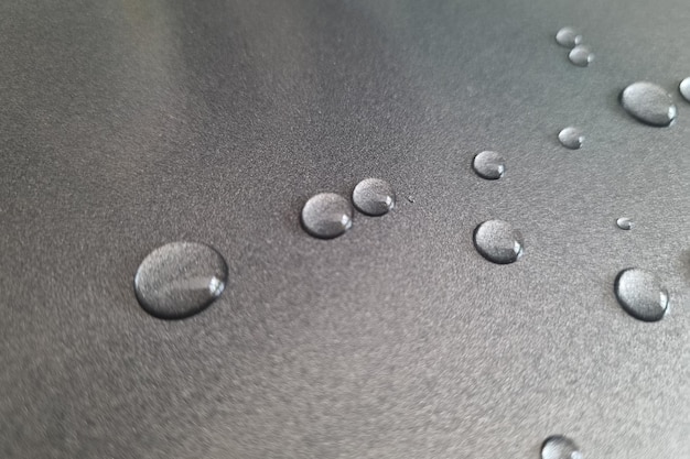 On the metal surface there are drops of water background