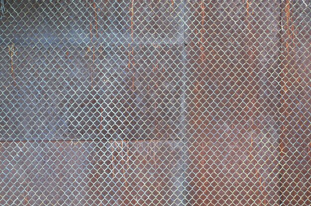 Metal texture with rusty mesh closeup in the daytime outdoors