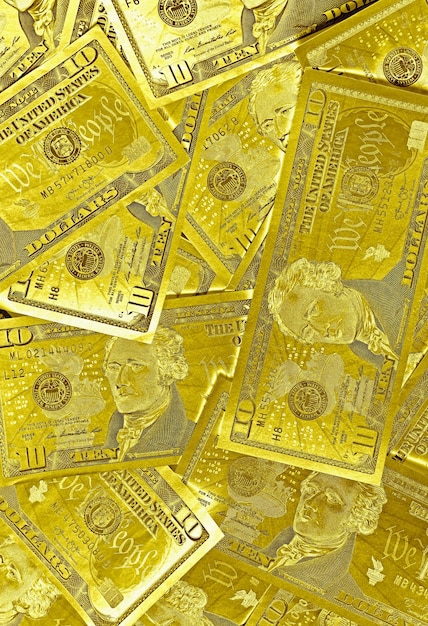 Metallic gold colored heap of United States ten dollar 10 bills