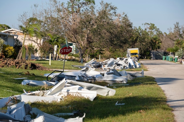 Metallic scrap rubbish on roadside from hurricane severely damaged houses in Florida residential are