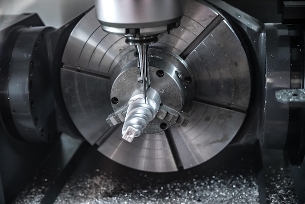 Metalworking CNC milling machine. Cutting metal modern processing technology. Small depth of field. Warning - authentic shooting in challenging conditions. A little bit grain and maybe blurred.