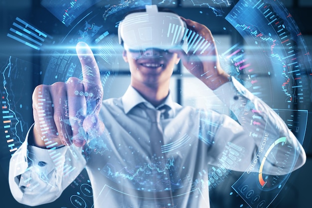 Metaverse trading and investing concept with happy young man wearing VR headset touching digital interface terminal with data double exposure