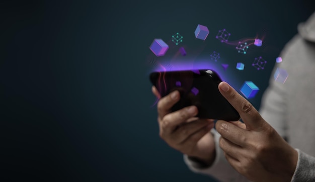 Metaverse Web3 and Blockchain Technology Concepts Closeup of Hand Using Smartphone for Connect a Community or Playing NFT Virtual Game