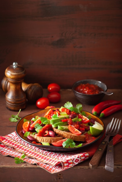 Mexican avocado bean sandwich with tomato chili scallion