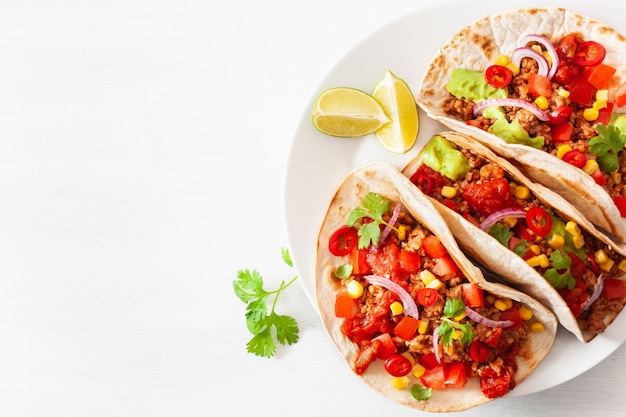 Mexican beef and pork tacos with salsa, guacamole and vegetables