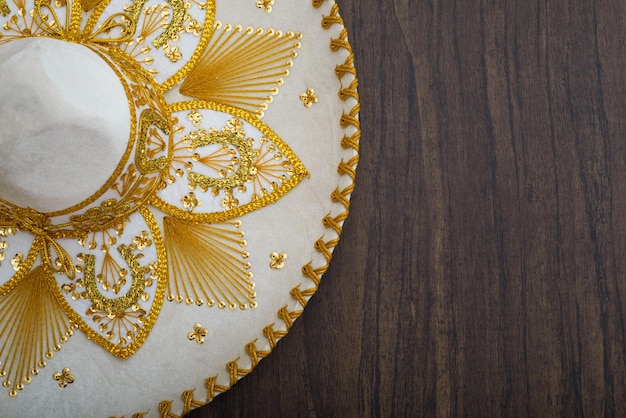 Mexican charro hat on wooden table Mariachi hat Typical mexican sombrero