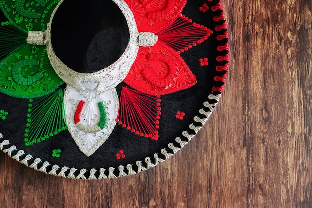 Mexican charro hat on wooden table. Typical mexican hat with the colors of the mexican flag.